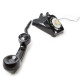 Old 60s - 70s style black telephone with rotary dial. Isolated on white. Hand set off the hook and u