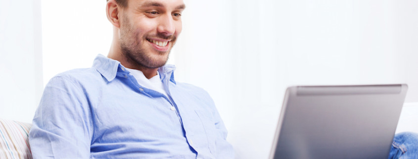 man using live chat with laptop at home